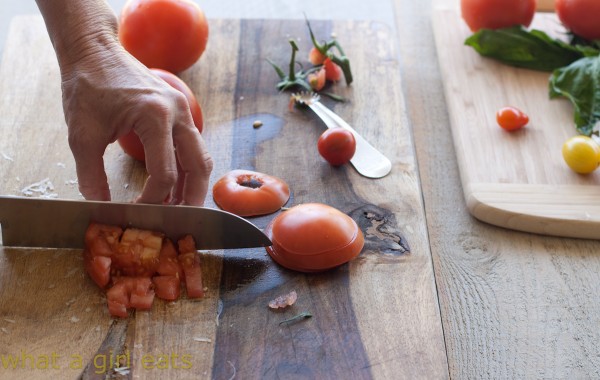 Chopping tomatoes.