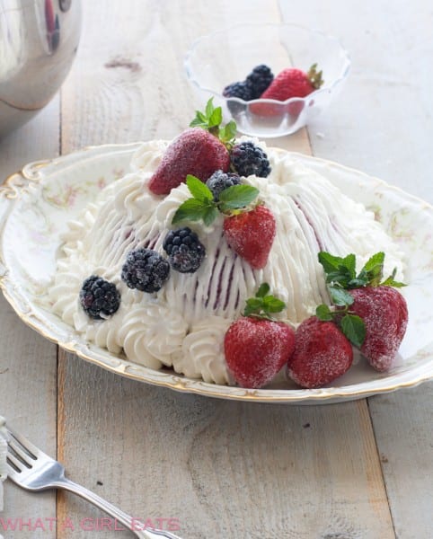 Classic British summer pudding, topped with fresh whipped cream and berries. 