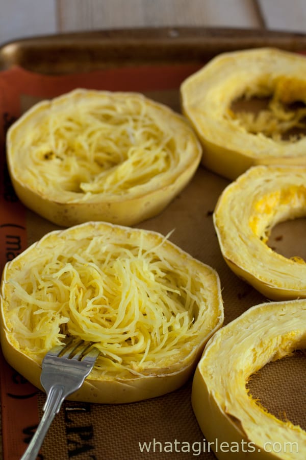 Squash sliced into rings on a baking sheet. 