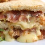 Panini sandwiches are warm and cheesy comfort food. This panini is filled with salty prosciutto, creamy brie cheese, fig jam, and caramelized onions.