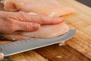 Slicing a chicken breast into paillards to make chicken piccata