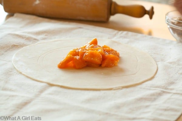 Apricots in a circle on dough.