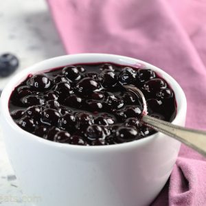 Blueberry compote in white bowl.