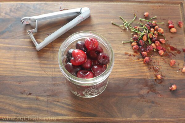 Packing cherries in jar.