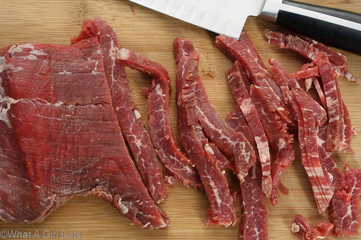 Flank steak, sliced thin across the grain. Freeze for 15 minutes to make slicing easier.