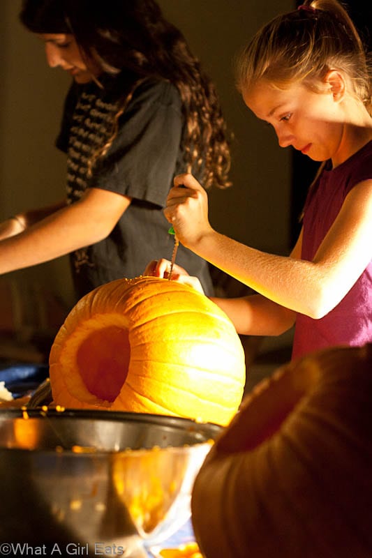 Young girls, having fun carving pumpkins (and later, eating roasted pumpkin seeds!)