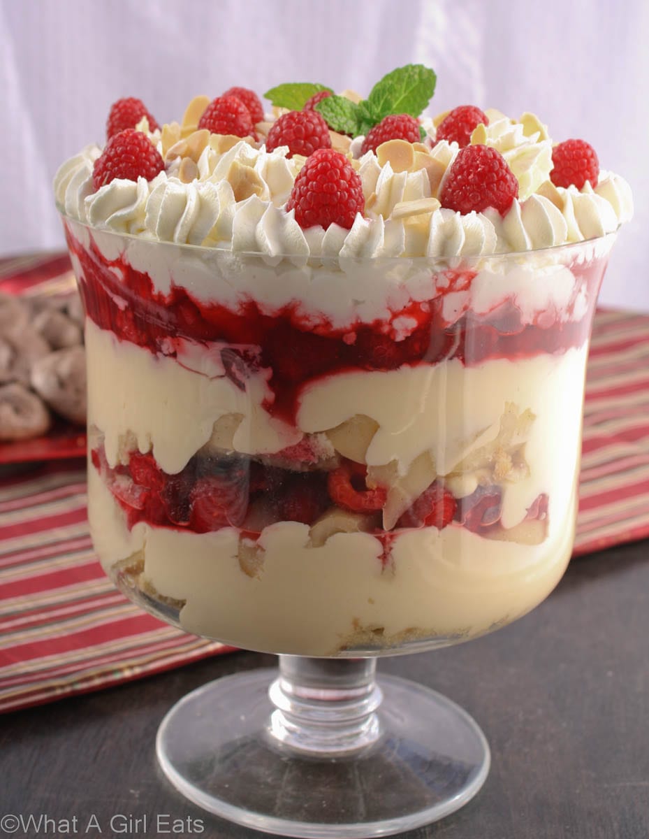 Christmas trifle with layers of pound cake, custard, raspberries, pears, and whipped cream. 