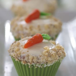 Carrot cake cupcakes are miniature versions of classic carrot cake. Moist carrot cake topped with creamy, decadent cream cheese frosting. The perfect gluten free Easter dessert! | @whatagirleats
