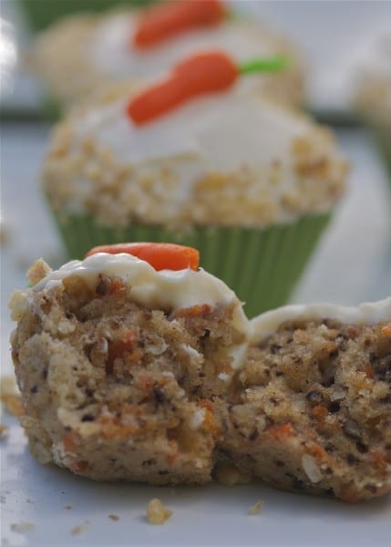 Carrot cake cupcakes are miniature versions of classic carrot cake. Moist carrot cake topped with creamy, decadent cream cheese frosting. The perfect gluten free Easter dessert! | @whatagirleats