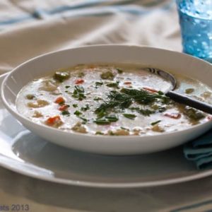 Greek Spring Soup is a heartier version of Greek Avgolemono soup. With a creamy broth and tender Spring vegetables, it's warm and comforting. | @whatagirleats
