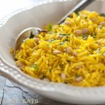 Golden rice pilaf in white bowl.