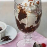 A tin roof sundae is a simple, but delicious dessert. Vanilla bean ice cream, homemade hot fudge sauce, and salted skin-on peanuts. | WhatAGirlEats.com