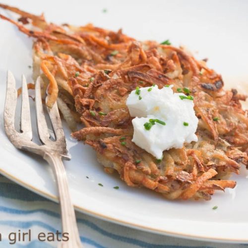 Crispy potato latkes are a delicious side dish, often served at Jewish meals around the holidays. Seasoned potato pancakes that are tender on the inside and crispy on the outside. | WhatAGirlEats.com