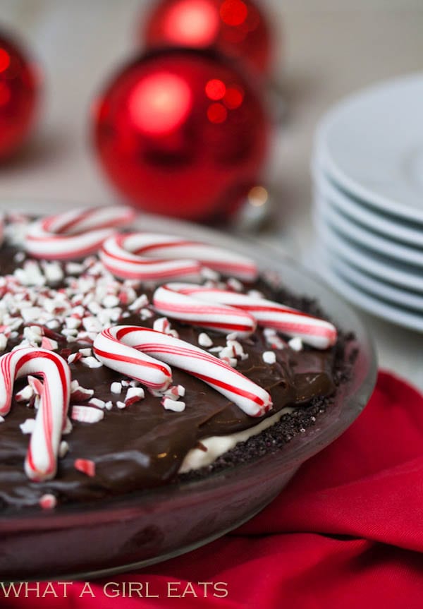 Candy cane ice cream pie is a festive holiday dessert that is so easy to make! A chocolate cookie crust holds creamy candy cane ice cream, hot fudge, and crushed candy canes.