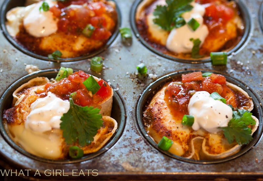 Mexican egg cups are a delicious, gluten free brunch treat, made with fluffy eggs, salsa, cheese and spices, baked inside of corn tortillas. | WhatAGirlEats.com