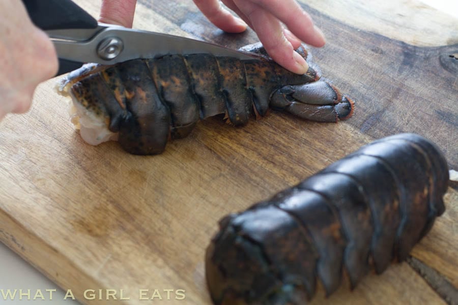 Cutting the shell of a lobster tail.
