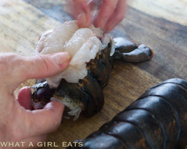 Preparing the lobster tail to be broiled.