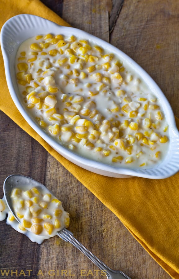 Homemade creamed corn in a white serving dish.