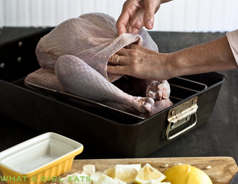 Lifting the skin of raw turkey to separate it from the meat.