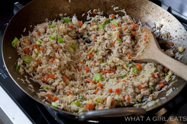 Pork fried rice is a flavorful Asian dish, packed with tender rice, bite sized pieces of pork, and crisp vegetables. Making it at home is incredibly quick and easy to do! | Recipe on What a Girl Eats