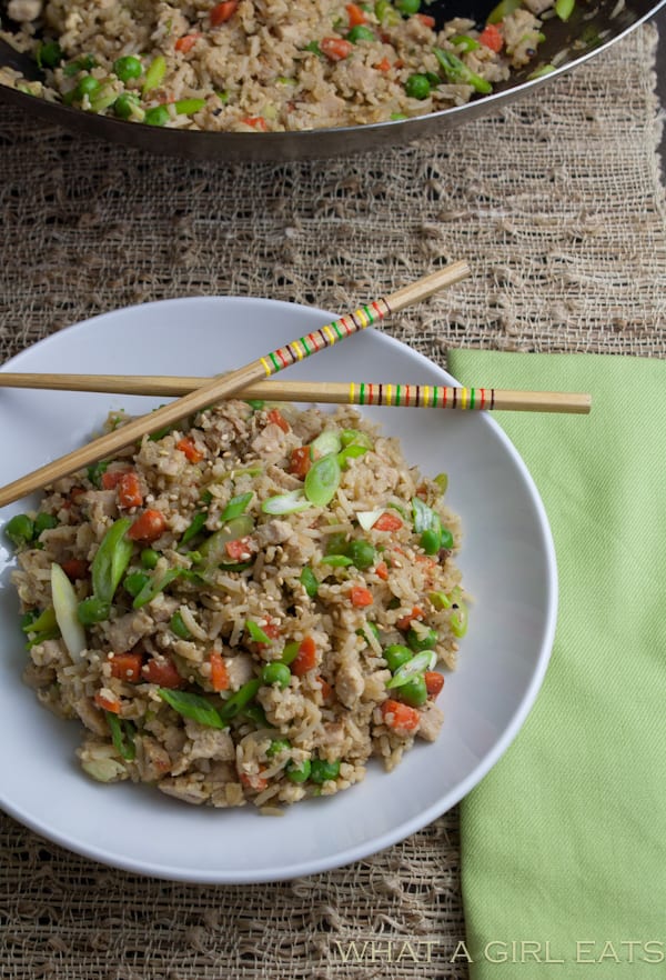 Pork fried rice is a flavorful Asian dish, packed with tender rice, bite sized pieces of pork, and crisp vegetables. Making it at home is incredibly quick and easy to do! | Recipe from What a Girl Eats