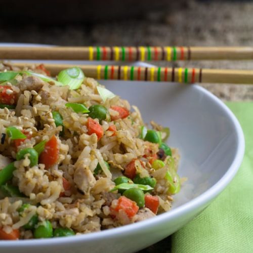 Pork fried rice is a flavorful Asian dish, packed with tender rice, bite sized pieces of pork, and crisp vegetables. Making it at home is incredibly quick and easy to do! | Recipe on whatagirleats.com
