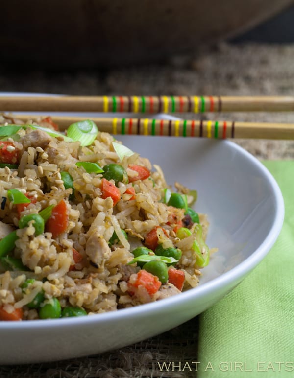 Pork fried rice is a flavorful Asian dish, packed with tender rice, bite sized pieces of pork, and crisp vegetables. Making it at home is incredibly quick and easy to do! | What a Girl Eats