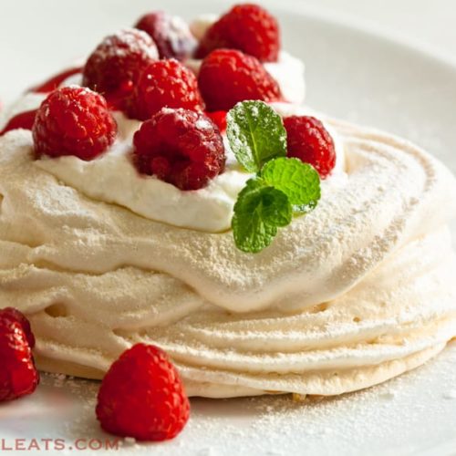 Meringue hearts with raspberries and whipped cream.