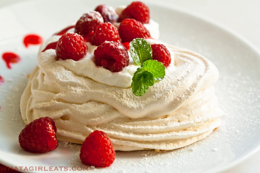 Meringue hearts with raspberries and whipped cream.