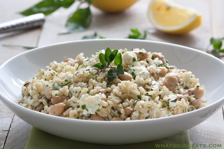 Mediterranean Rice Salad With Herbs And Feta in a white bowl.