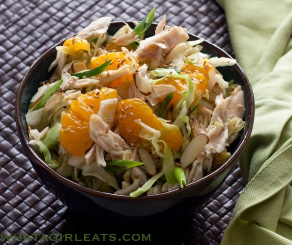Chinese Chicken Salad, crisp cabbage, shredded chicken in a slightly sweet dressing with sliced almonds and mandarin oranges.@whatagirleats.com