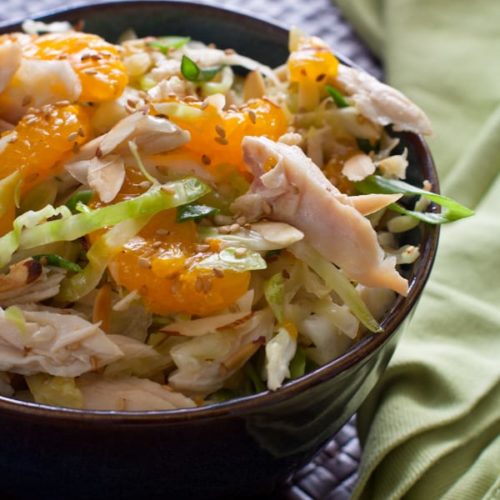 Chinese Chicken Salad, crisp cabbage, shredded chicken in a slightly sweet dressing with sliced almonds and mandarin oranges.@whatagirleats.com