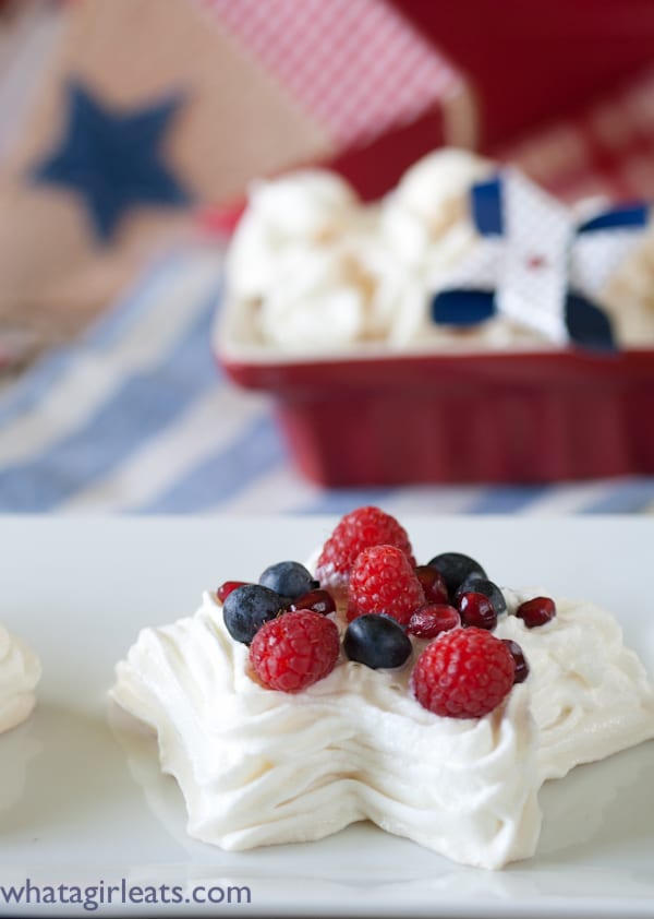 close up shot of single star meringue with berries.