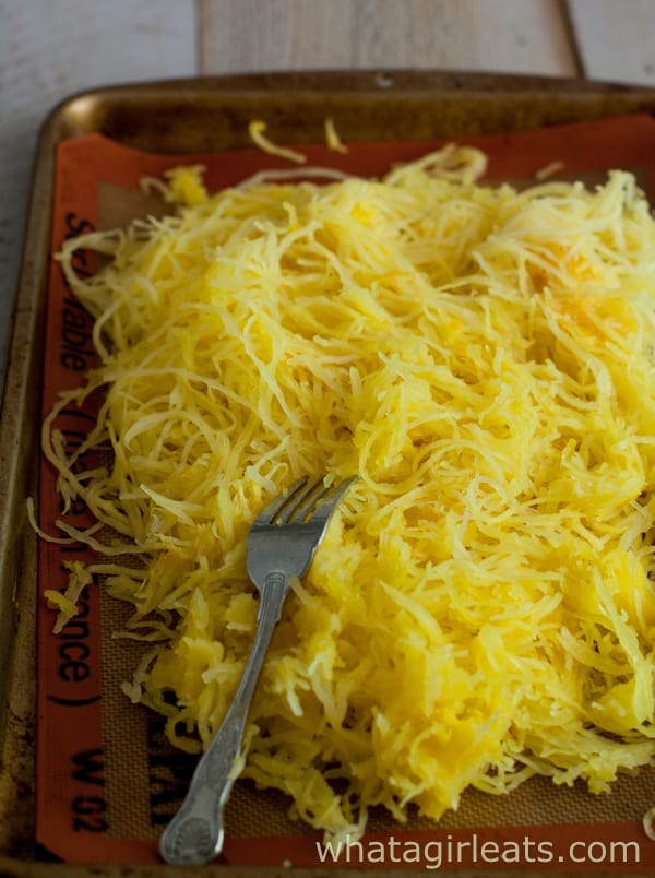 Spaghetti squash pasta on a baking sheet with a fork.
