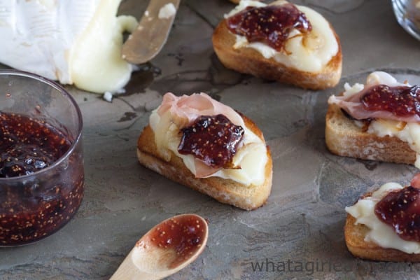 Brie with caramelized onions, prosciutto, and fig jam is an easy-to-make appetizer that works well for all occasions, from dinner parties to game day parties! | WhatAGirlEats.com