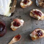 Brie with caramelized onions, prosciutto, and fig jam ﻿is an easy-to-make appetizer that works well for all occasions, from dinner parties to game day parties! | WhatAGirlEats.com