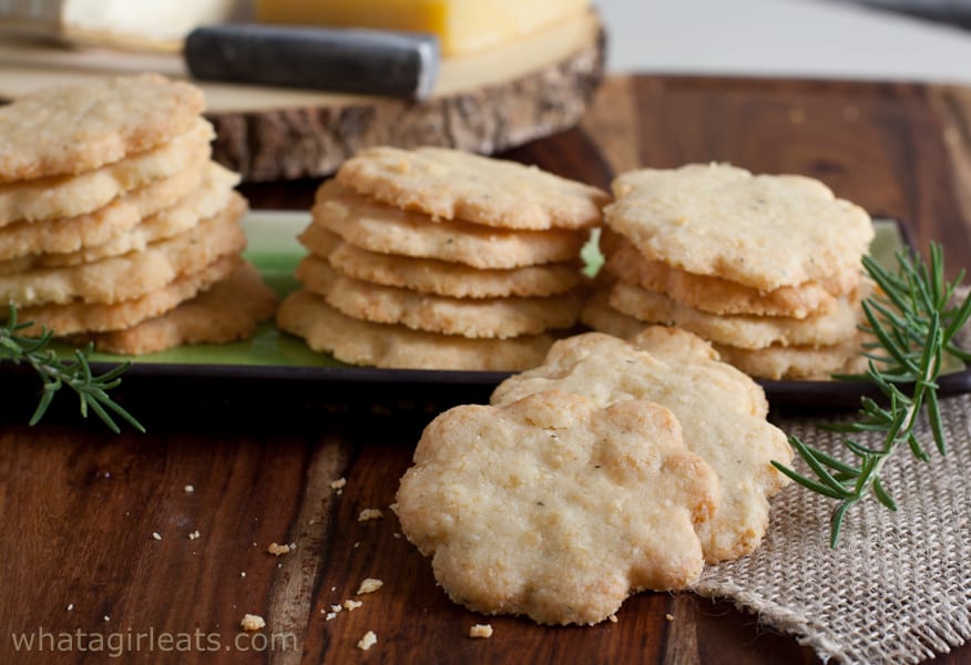 Cheddar rosemary shortbread cookies piled on a platter.