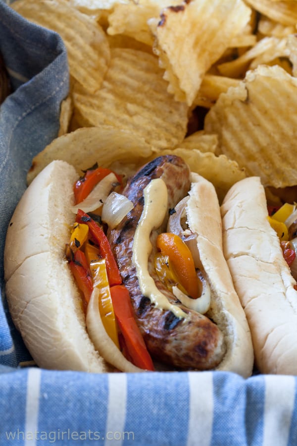 Bratwurst subs with spicy pub mustard and grilled onions and peppers.