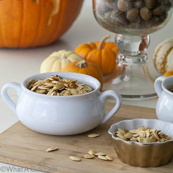 Part of the Halloween fun is roasting pumpkin seeds! Roasted Pumpkin Seeds with Wasabi - Get the recipe from WhatAGirlEats.com