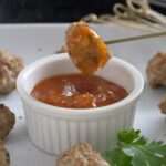 sweet and sour pork balls on skewer.