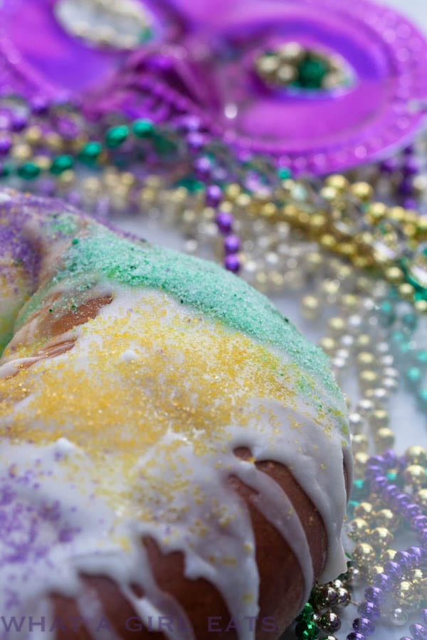 King Cake with icing and colored sugar on top.