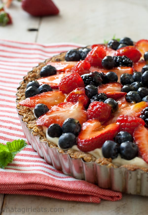 Red white and blue dessert tart with strawberries, blueberries, and raspberries.