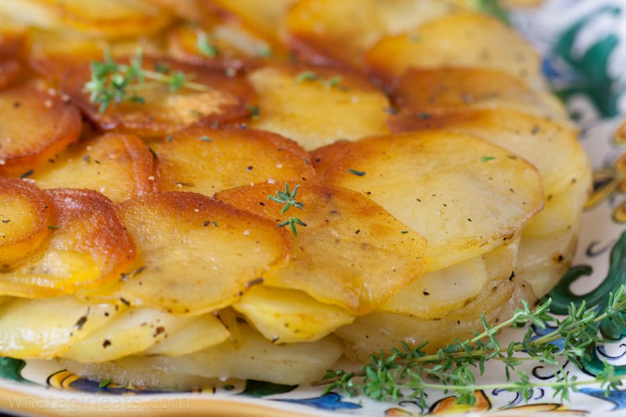 Closeup of golden Pommes Anna on a plate.