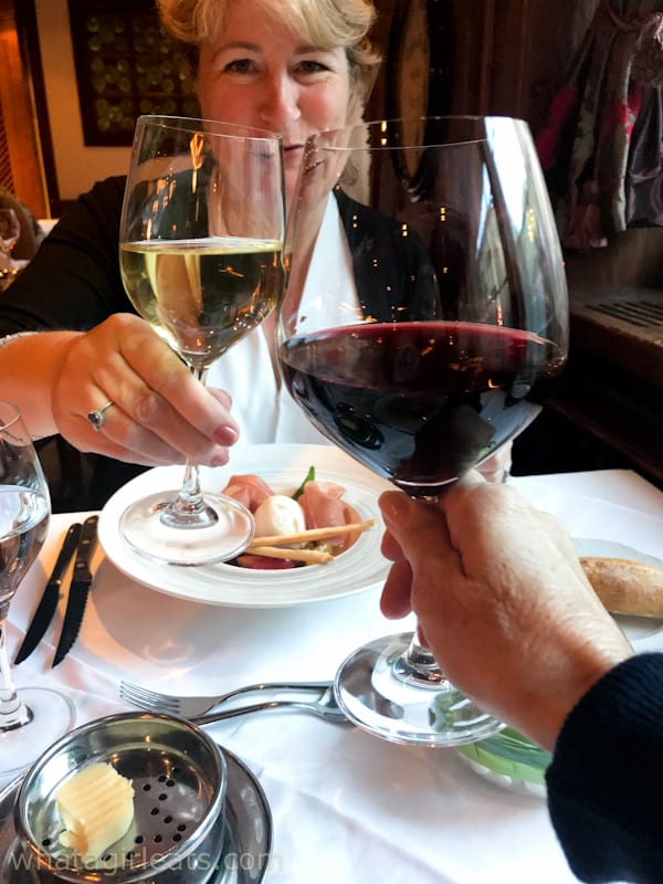 Toasting wine glasses at dinner at the Alex Grill.