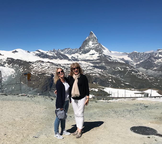 Two women laughing, Matterhorn in background.