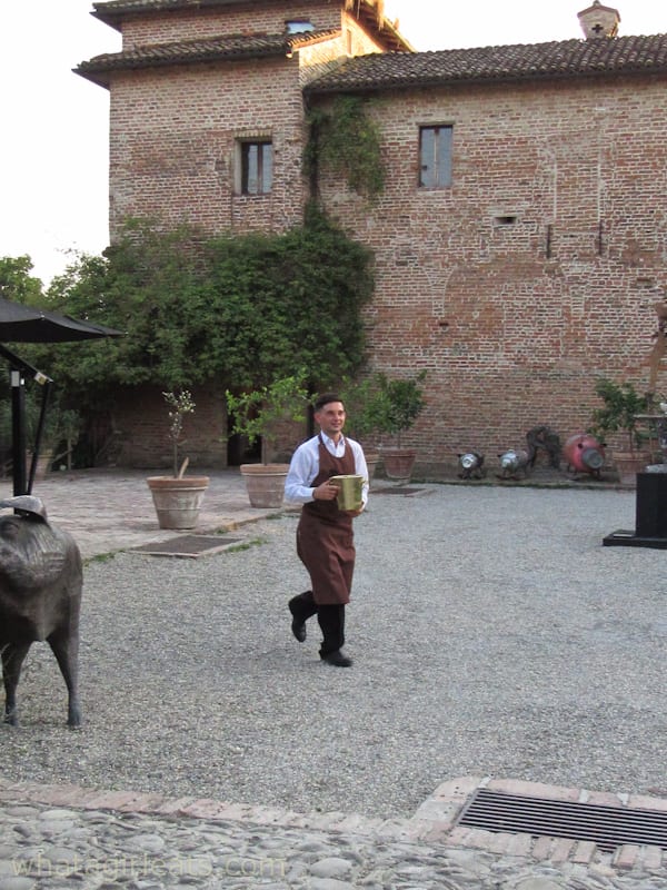 courtyard and waiter at Antica Corte Pallavicina: A Relais In Northern Italy