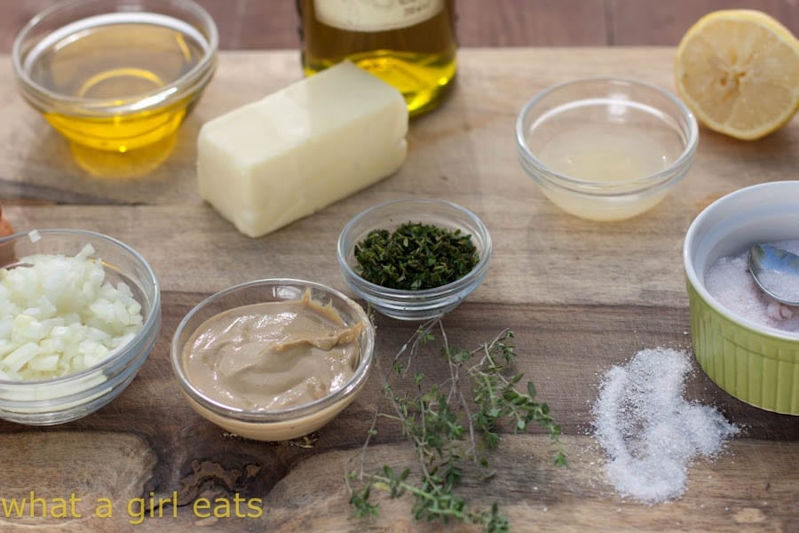 Marinade ingredients in small bowls on a cutting board.