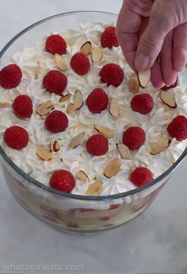 Putting almonds on a trifle.