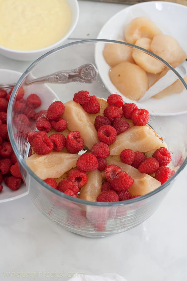 Raspberries and pears in a trifle bowl.