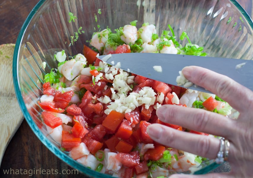 Adding the diced tomato to shrimp cocktail